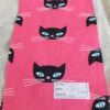 Cotton print fabric in cat print theme, with cat faces made on pink cotton, for children's clothing, quilting, sewing and dresses.