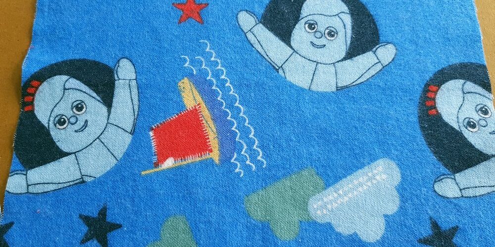 Cotton print fabrics with cartoon animated prints of a girl and sail boats