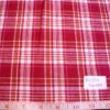 Madras plaid fabric in red, orange and white plaids