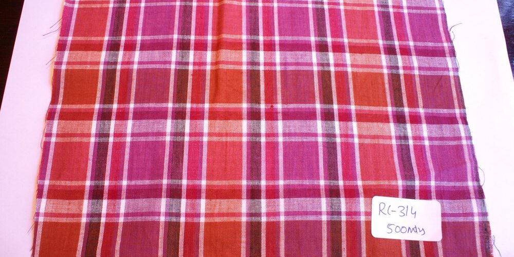 Madras fabric in fuschia, red, brown and white plaid