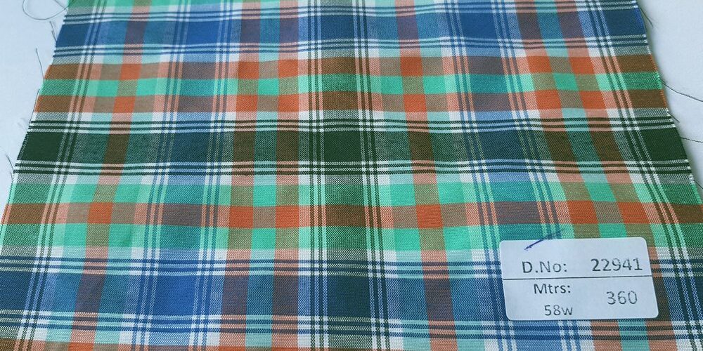 Check Fabric sometimes also known as madras plaids are a fabric made of cotton in a criss cross of lines of various colors, perfect for shirting and ties.