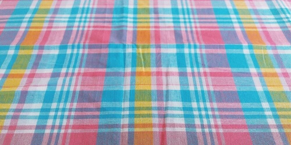 Plaid Fabric or madras plaid is made of cotton yarns in a plaid pattern. It is a summer preppy fabric, for shirting, menswear, kids clothing and beach wear.