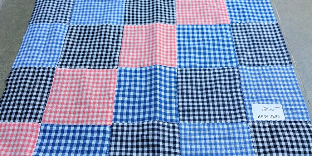 Gingham Patchwork fabric made of gingham squares sewn together into a patchwork fabric for shirts, boy's clothing and menswear.