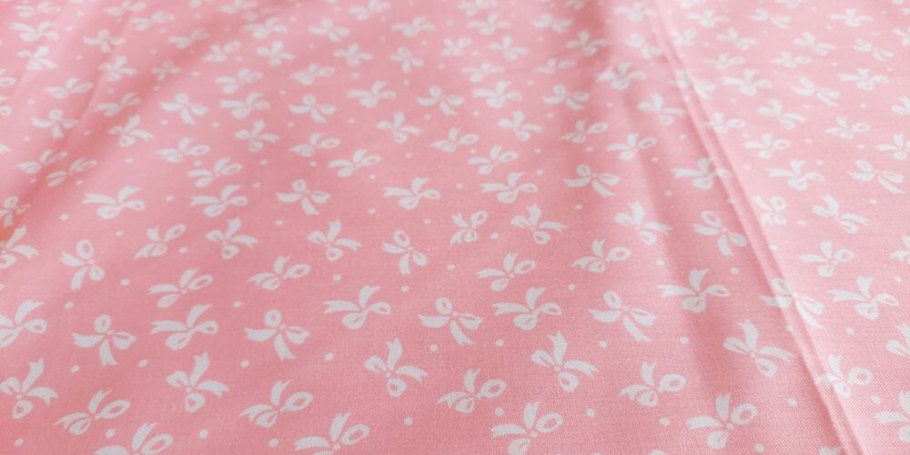 Bow print fabric, with gift bows on a pastel pink base