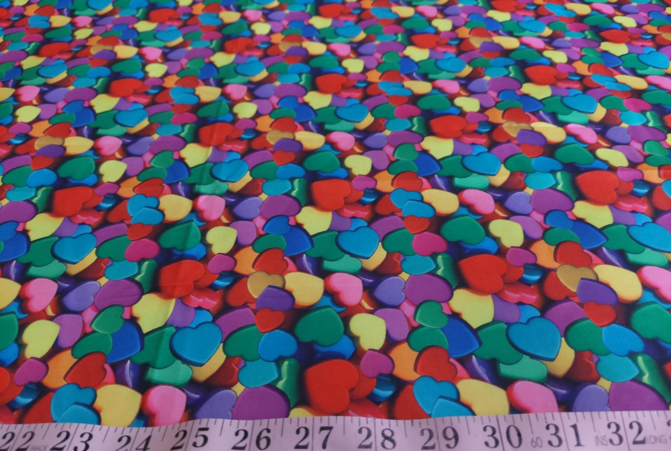 Hearts theme or love theme printed fabric with hearts printed in various colors.