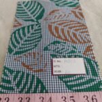 Novelty Print fabric with leaves printed on a gingham plaid base, for children's clothing, quilting, dog bandanas and dresses.