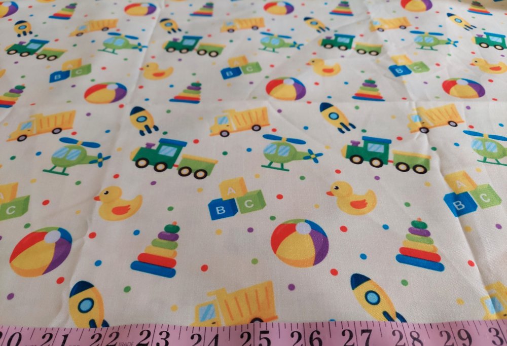 Cotton print fabric with dump trucks, trains, rockets, helicopters & ducks, for children's clothing, quilting, sewing and dresses.