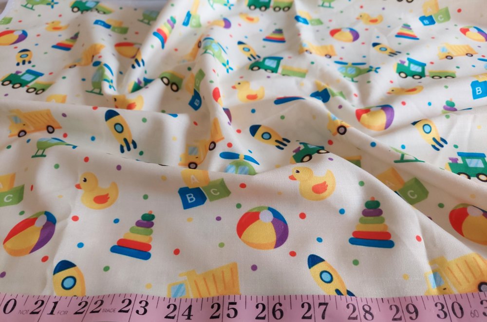 Cotton print fabric with dump trucks, trains, rockets, helicopters & ducks, for children's clothing, quilting, sewing and dresses.