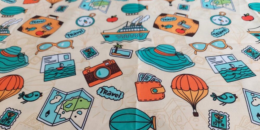 Cotton print fabric in travel and holiday theme, with travel bags, for children's clothing, quilting, sewing and dresses.