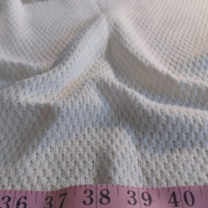 Organic cotton fabric with an eyelet knit pattern, for eco & organic clothing like organic capes, stoles, dresses and skirts.