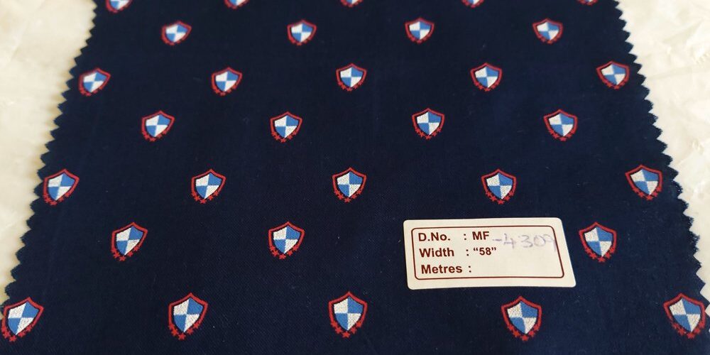 Novelty Print Fabric with blue shields, for sewing children's clothing, dresses, skirts, dog & cat bandanas and bows.