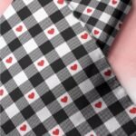 Black and white gingham with hearts print fabric with hearts printed for handsewn children's clothing, dog bandanas & bows.
