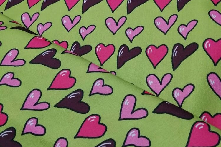 Novelty fabric with hearts printed, on olive green, for quilting, skirts, bowties, children's clothing & dog and bandanas.