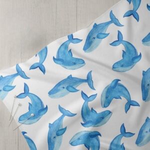 Novelty print fabric with blue whales print for dog bandanas, bows, vintage clothing, resort wear & children's clothing.