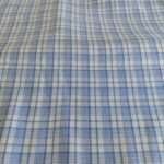 Tattersall Check or Tattersall Plaid Fabric, with vertical stripes that repeat horizontally, forming squares, ideal for shirts.