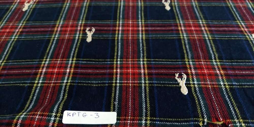 Flannel check fabric with Christmas reindeers embroidered, for shirts, outdoor clothing, Fall clothing & children's clothing.