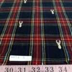 Flannel check fabric with Christmas reindeers embroidered, for shirts, outdoor clothing, Fall clothing & children's clothing.